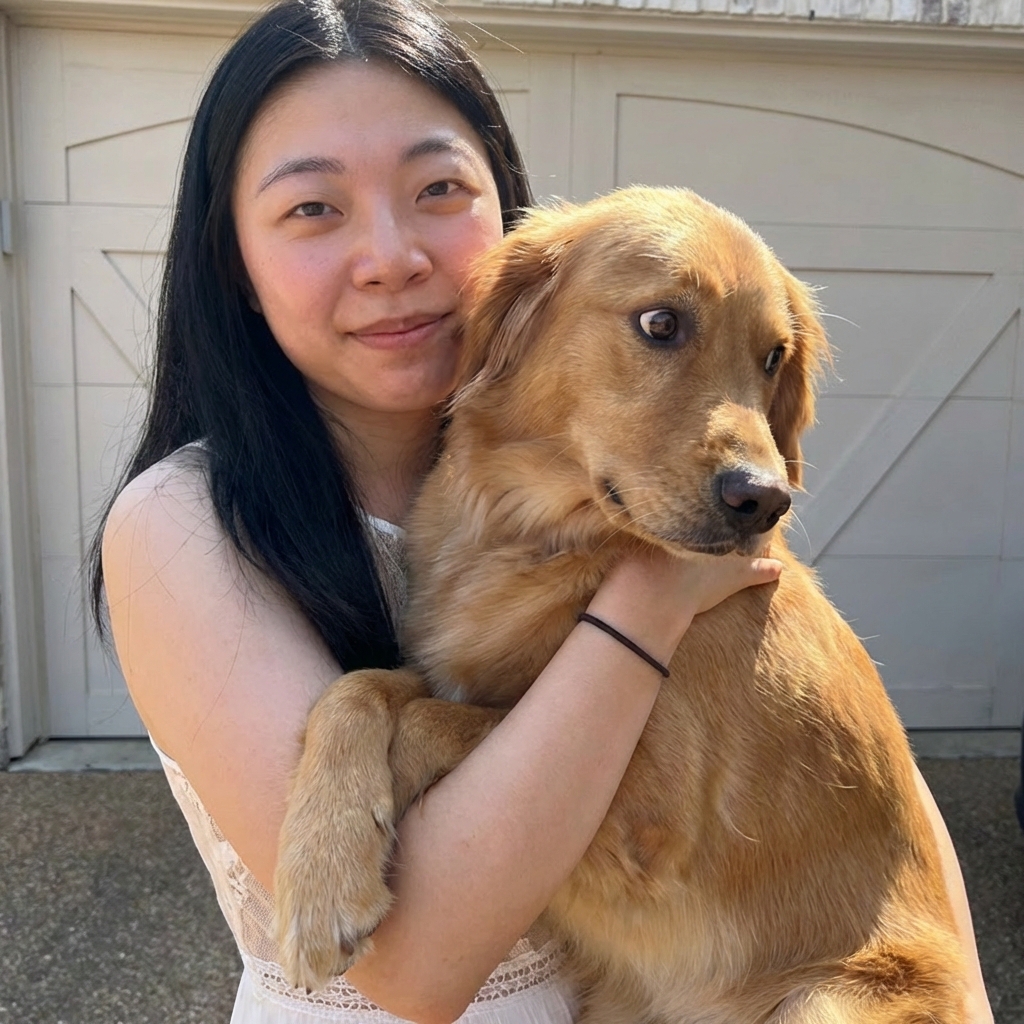 A close-up photo of a dog being gently held by an owner while the dog looks uncomfortable